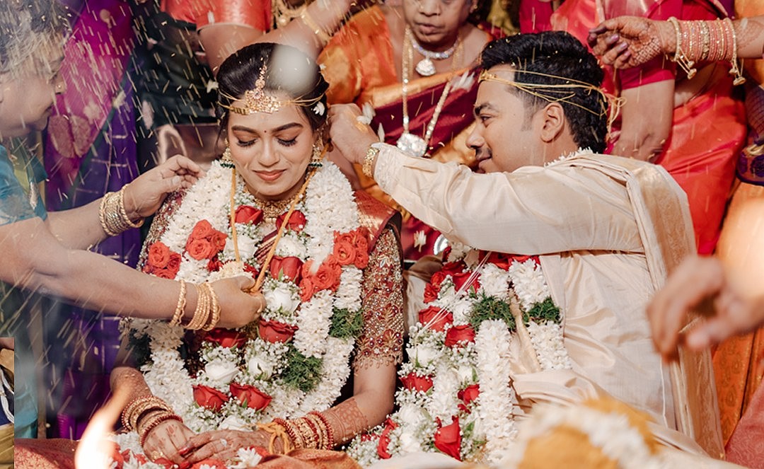 Blessings and petals showering over a smiling couple