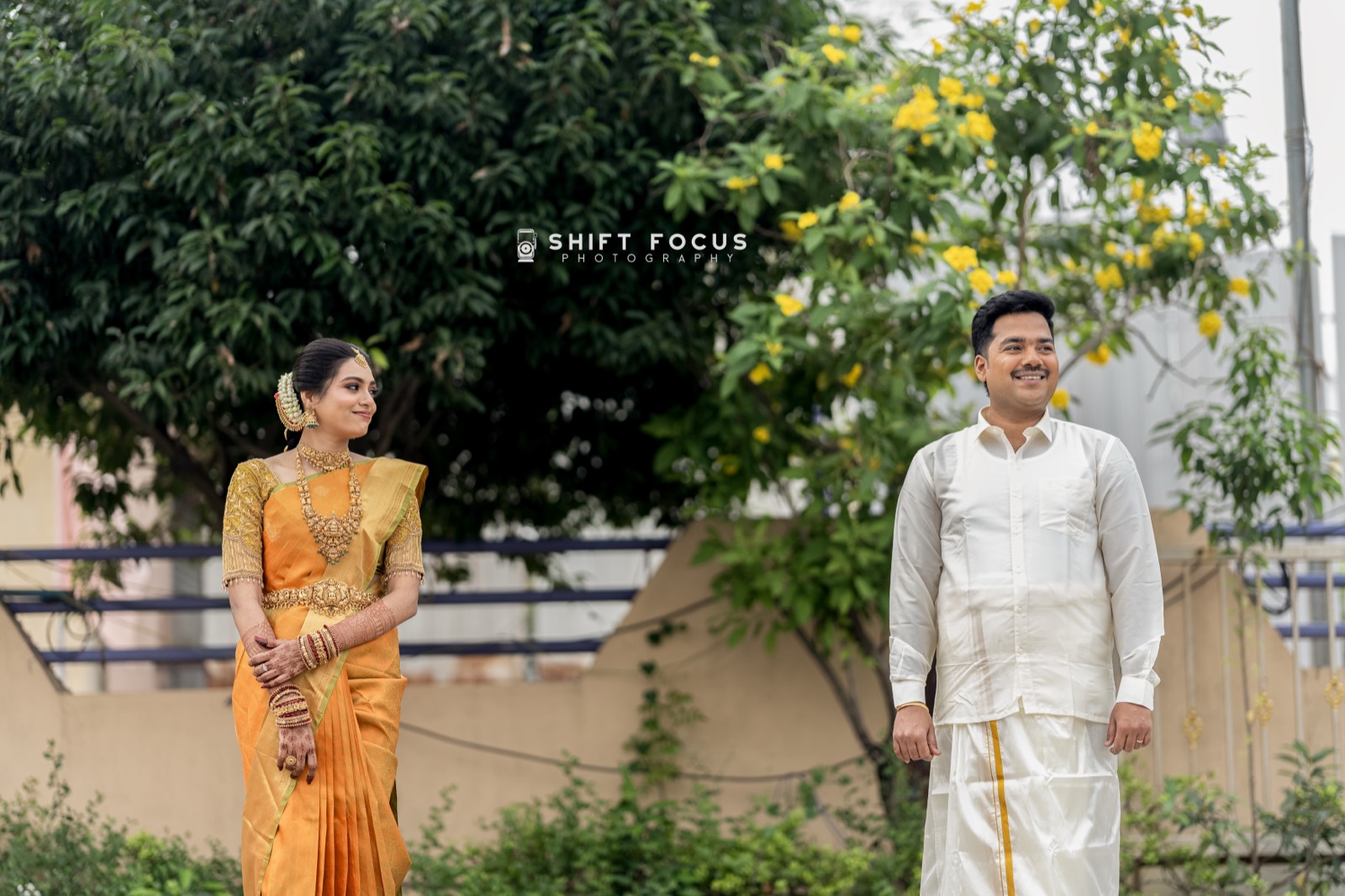 A bride and groom in a Chennai garden, moments after the ceremony